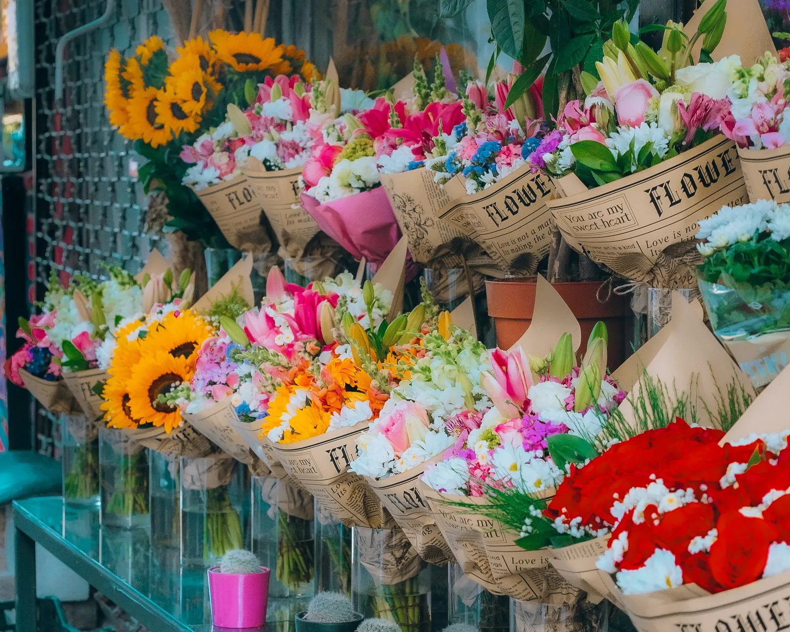 A vibrant display of floral bouquets with sunflowers and lilies in an Istanbul flower shop.